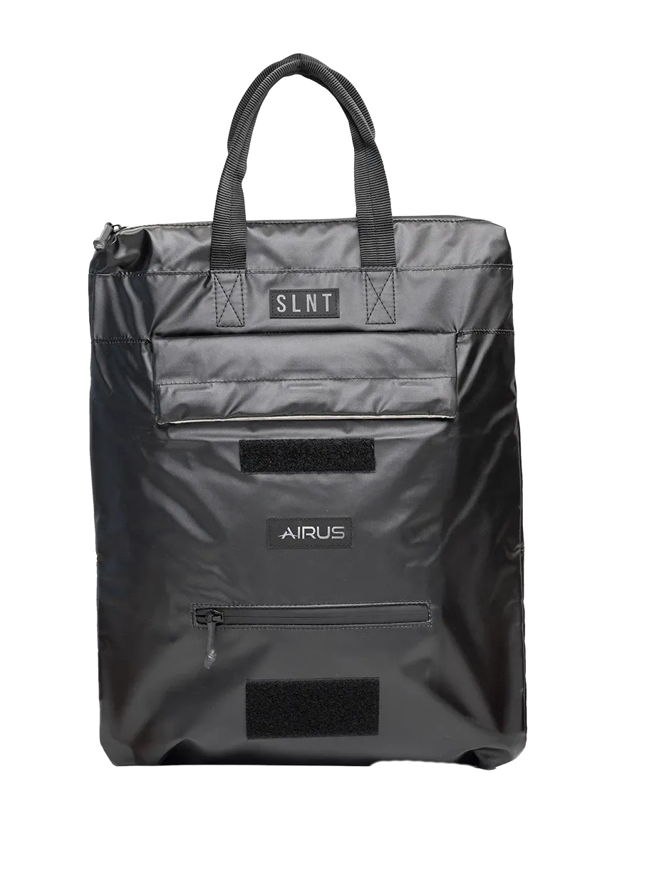 The front of the AIRUS carry bag, with the SLNT patch, the top pocket, the AIRUS patch and a zipped pocket below it.
