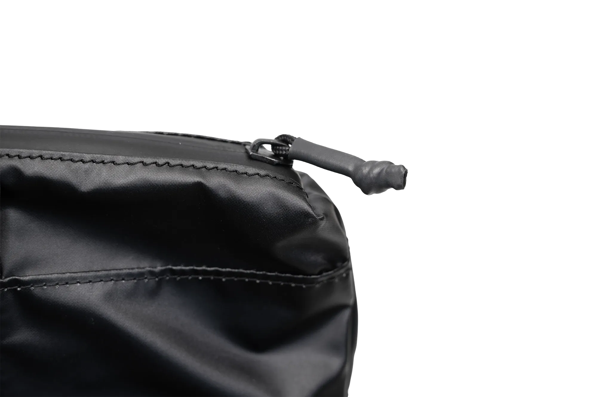 The carry bag's top zipper closed, with the moulded pull resting against the body.