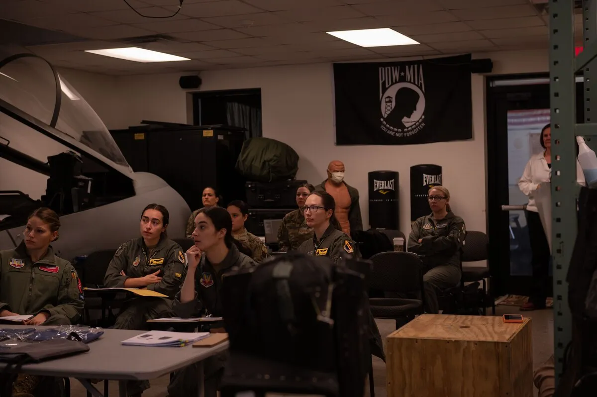 Pilots and weapons systems officers of the 4th Fighter Wing in the pre-brief before the first fitting session.