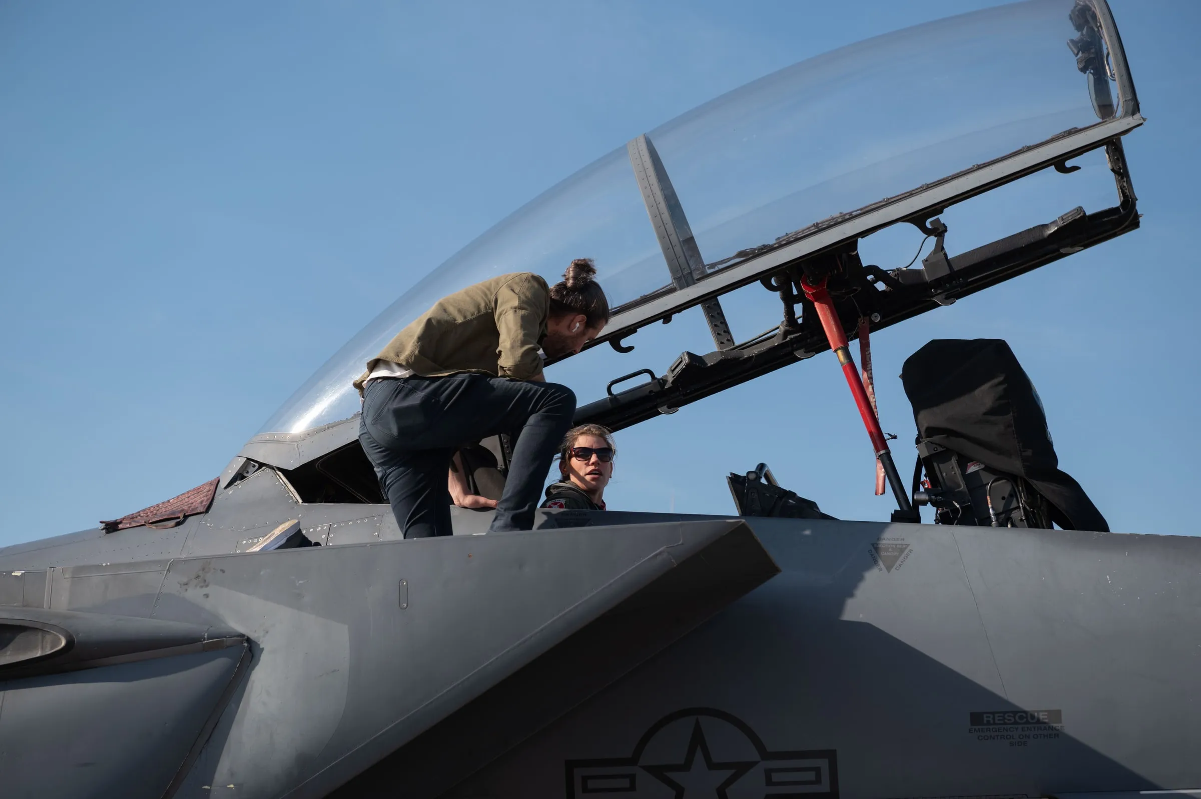 Colt Seman, AIRION chief of design, fits the AIRUS system with a 4th Fighter Wing aircrew member in the cockpit of an F-15E at Seymour Johnson Air Force Base.