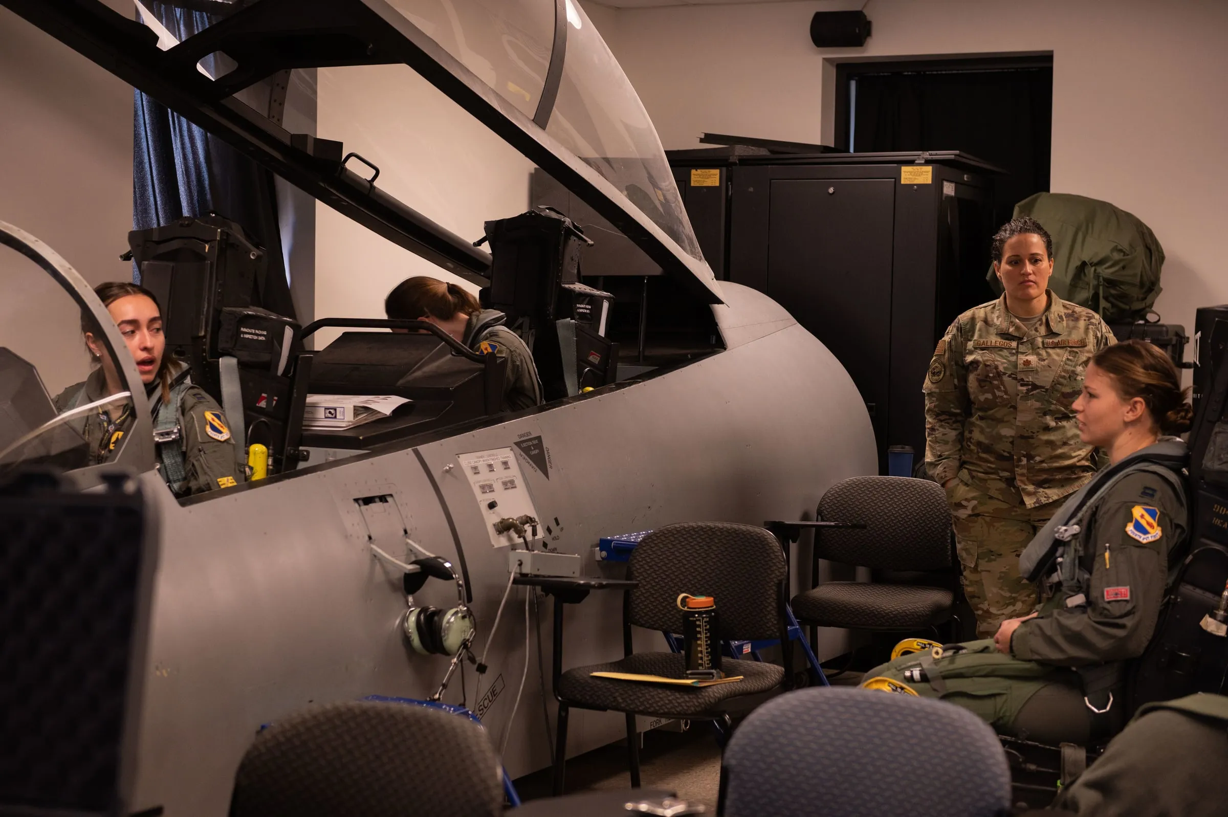 Fit checks in the cockpit trainer — seat geometry and harness routing are what ground integration is for.
